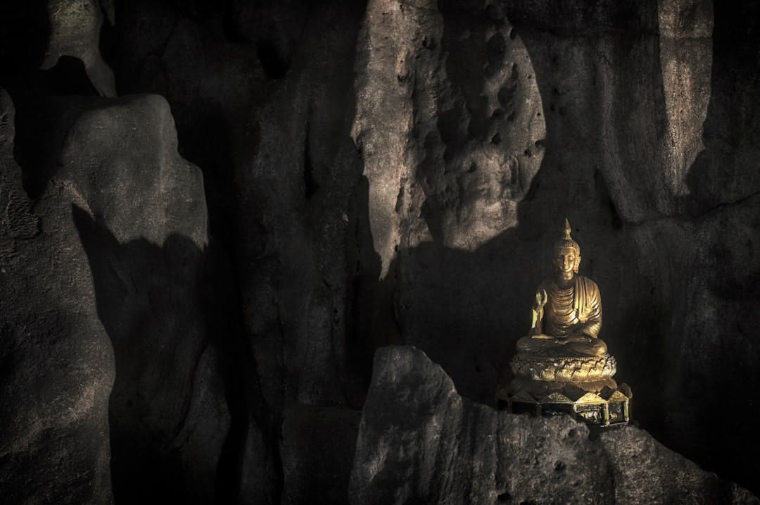 gold buddha statue in cave