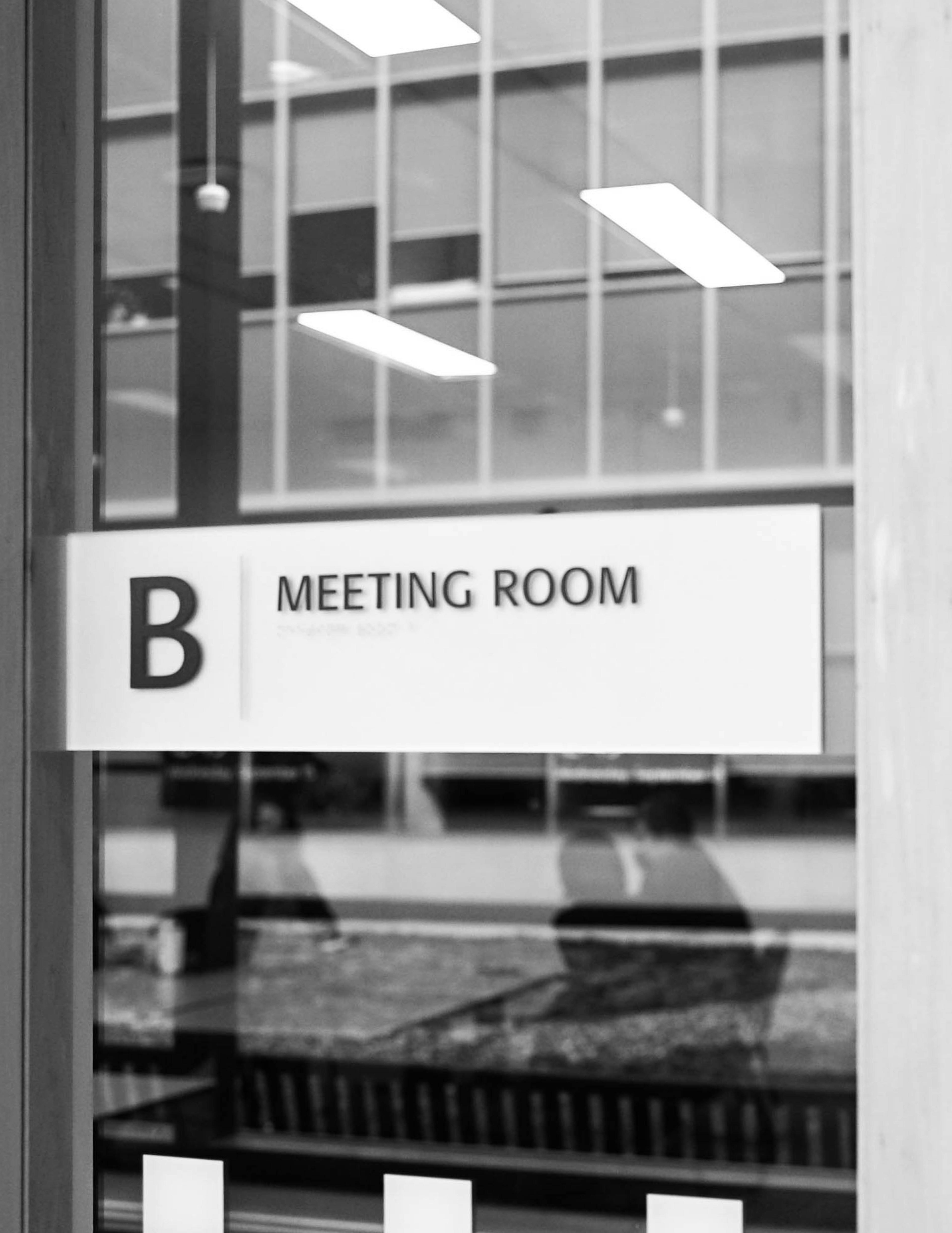 a black and white photo of a meeting room