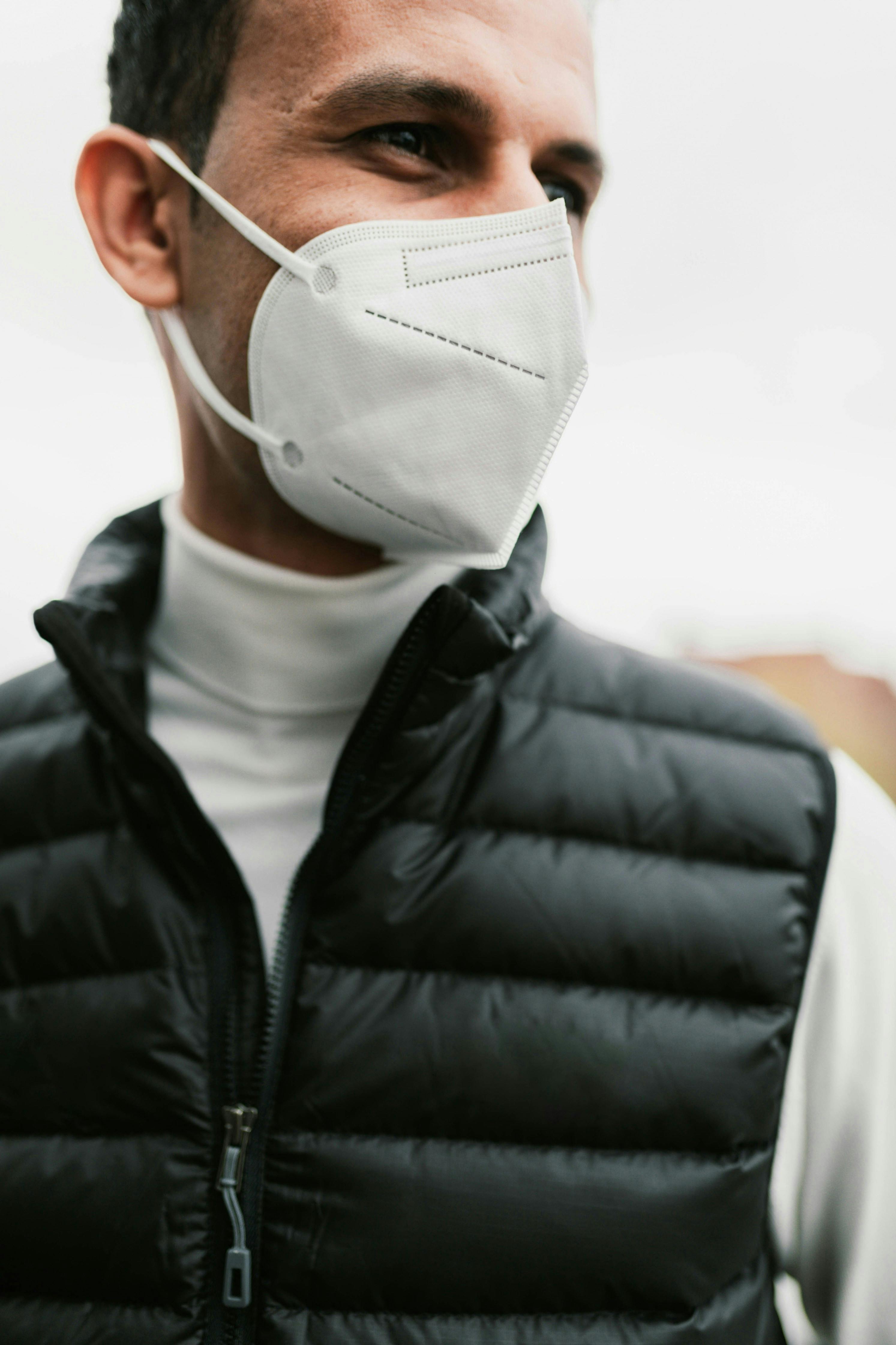 a man wearing a white face mask