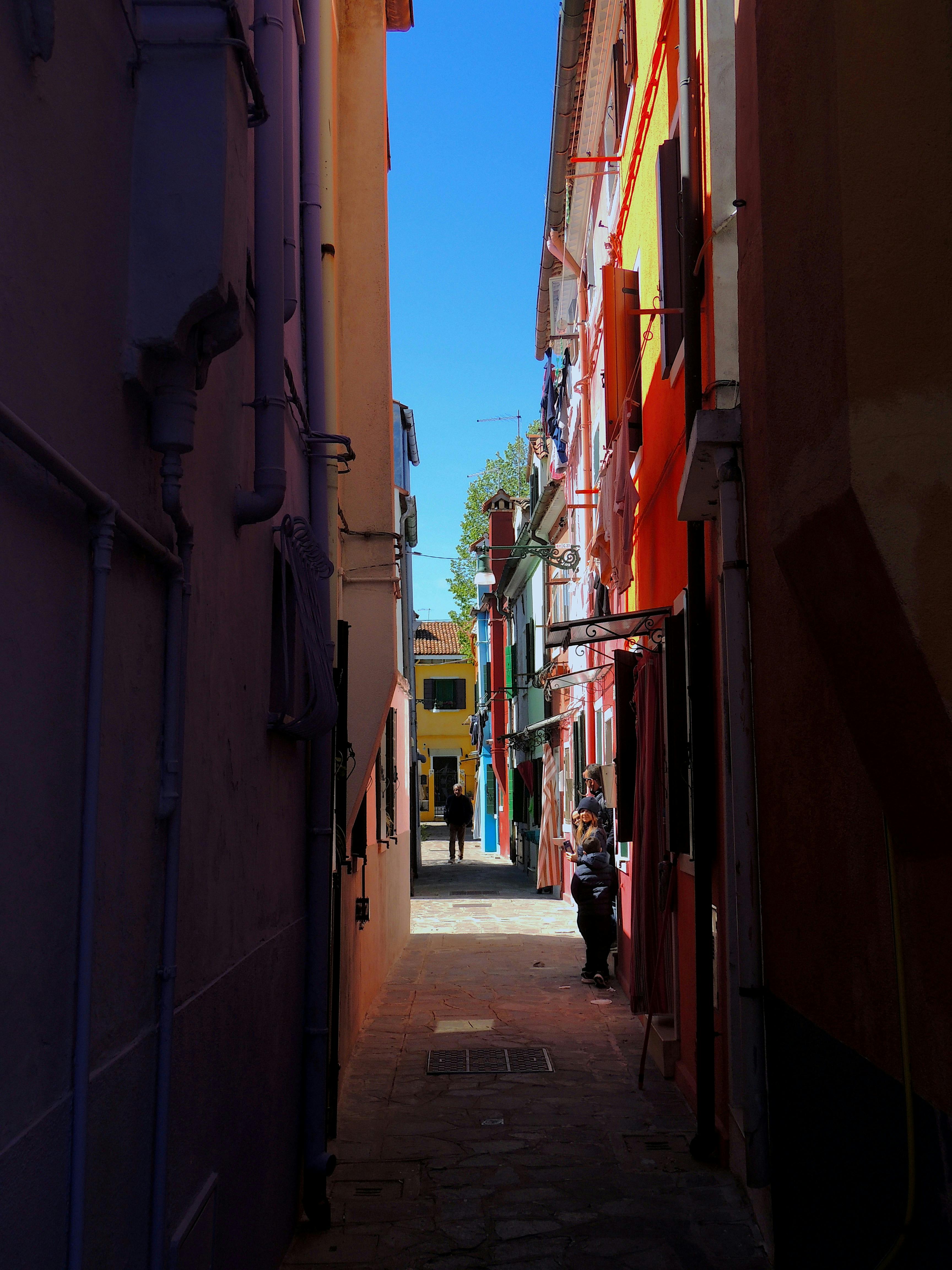 a narrow alley between two rows of buildings