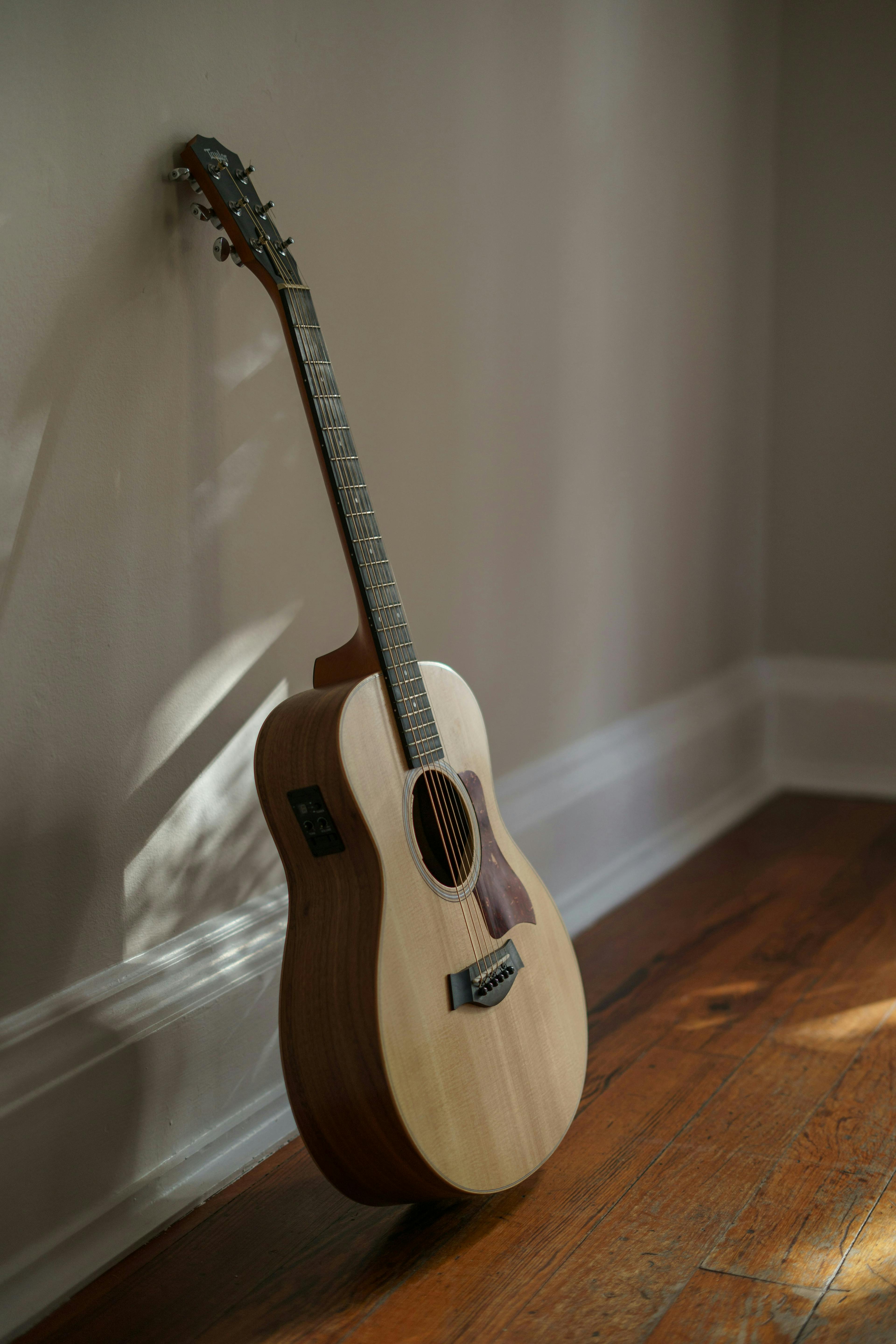 a guitar leaning against a wall
