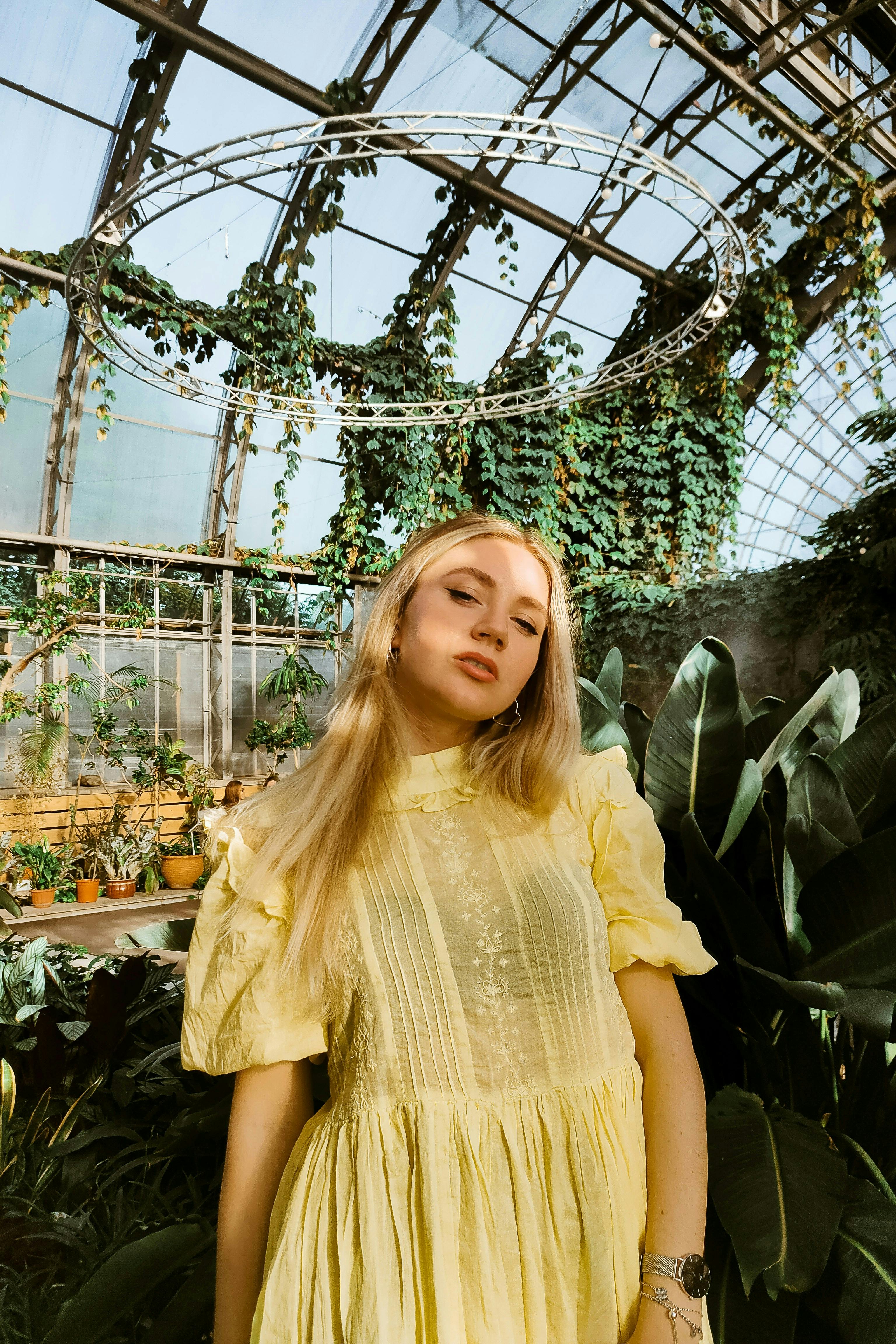 a woman standing in a greenhouse